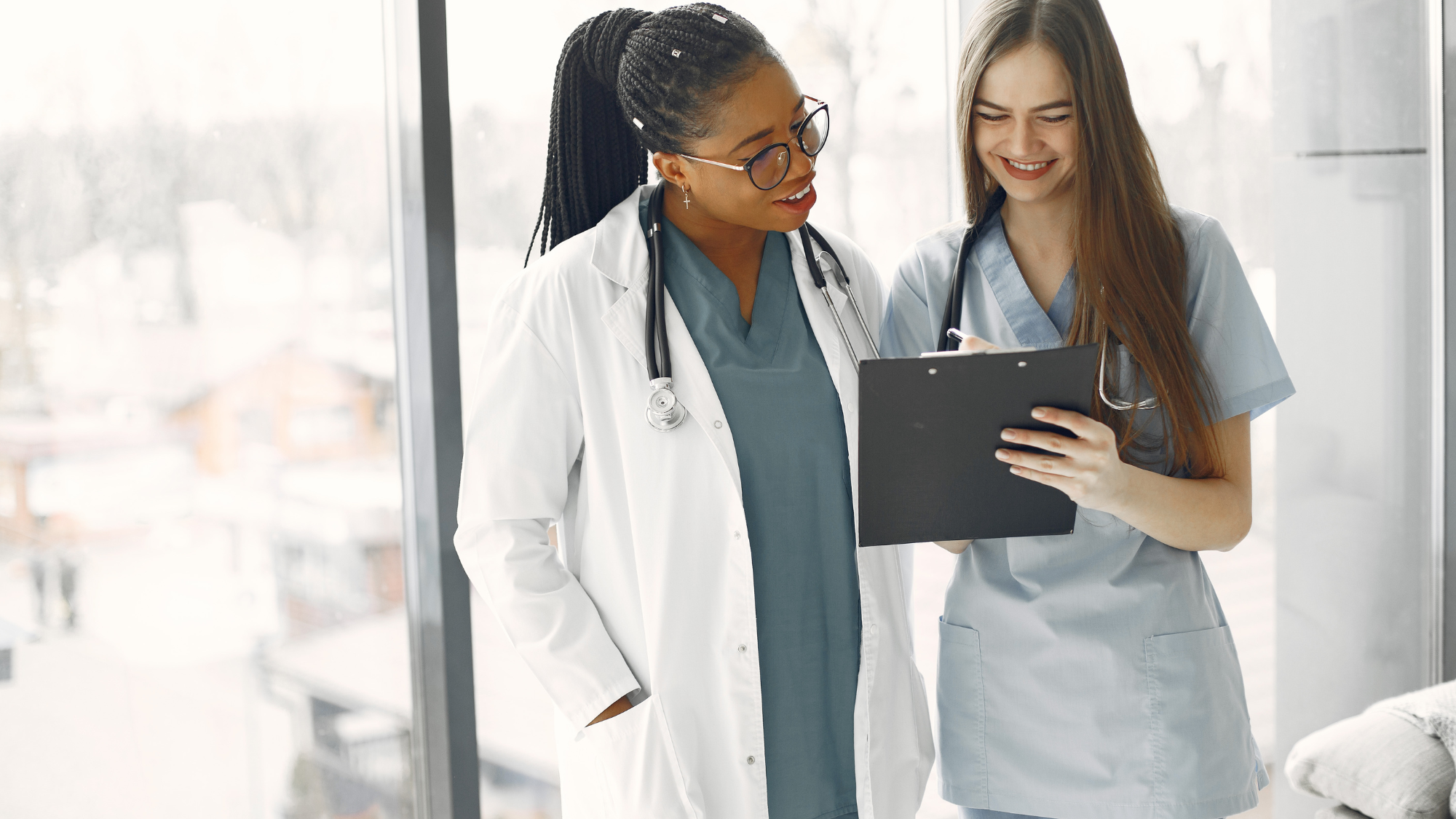 Two healthcare providers reviewing records managed in a no-code healthcare CRM platform
